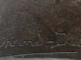 a close up of a clock on a wooden table