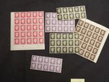 a group of four different colored stamps on a black surface