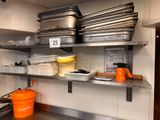 many pots and pans on the shelves in the kitchen