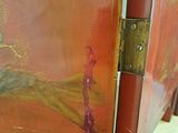 a painting on the door of a room with a chair