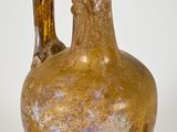 a brown vase that is sitting on a white surface