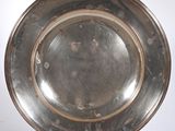 an antique silver plate on a white background with a white background