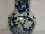 a blue and white vase with a bird on it