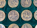 nine coins in a wooden box with velvet lining