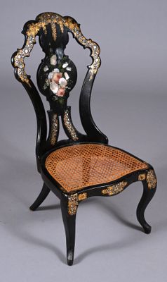 a black chair with a floral design on the back