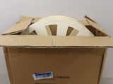 cardboard box with a white disc in it sitting on a table
