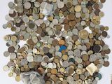 a pile of coins sitting on a table next to a bag