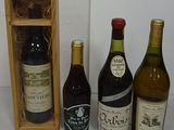 several bottles of wine are lined up in a row next to a wooden box