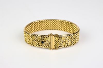 a gold mesh bracelet with a clasp