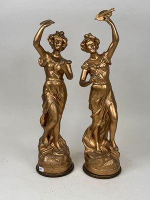 pair of antique bronze figurines of a woman and a man
