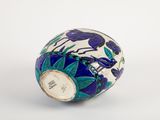 a blue and white vase sitting on a white surface