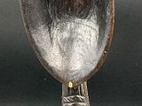 a silver spoon sitting on top of a metal stand