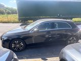 a picture of a black car parked in a parking lot