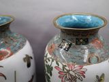 two vases sitting side by side on a table