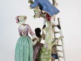 a figurine of a man and a woman on a ladder