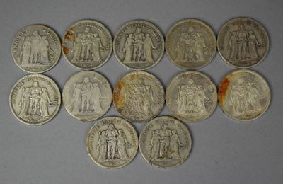 six different types of silver coins on a white surface