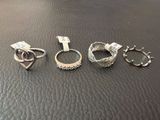 three rings and a key are sitting on a leather surface