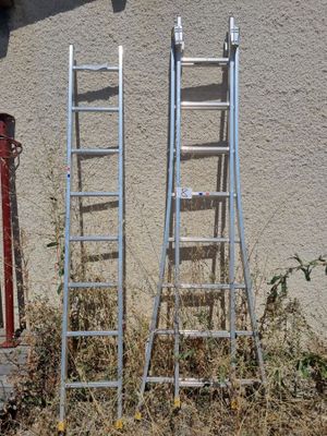 two ladders leaning against a wall next to a fire hydrant