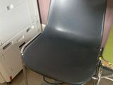 a chair that is sitting next to a washing machine