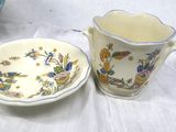 a cup and saucer sitting on a table next to a plate