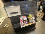 a display case with magazines on it in a store