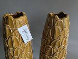 two vases that are sitting on a table