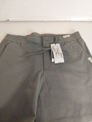 a pair of grey shorts with a tag on the side