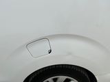 a close up of a white car with a flat tire