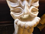 a stone statue of a face on a window sill