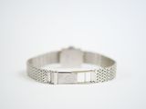 silver bracelet with a square stone in the middle of it