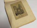 an old book with a drawing on it sitting on top of a table