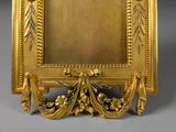 an image of a gold frame with a picture of a bird
