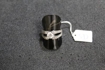 a ring that is sitting on a table next to a price tag