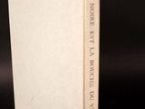 an old book sitting on top of a table next to a black background