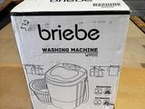 box of briebe washing machine sitting on a table in a room