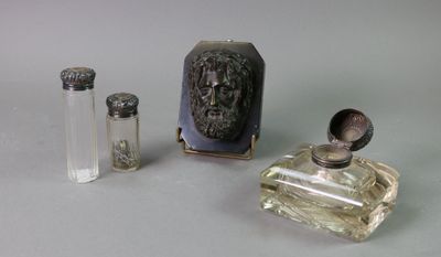 three bottles of perfume sitting next to each other on a table