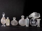 many different glass bottles sitting on a black surface