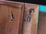 an old key sitting on top of a wooden cabinet
