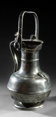an old silver vase with a handle on a black background
