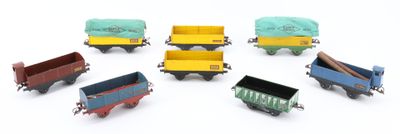 six toy trains that are sitting on a white surface