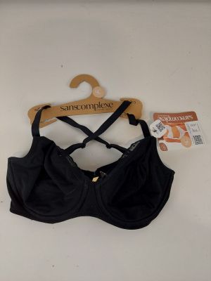 black bralette on a wooden hanger with a tag on it