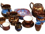 many different types of teapots and cups on the table