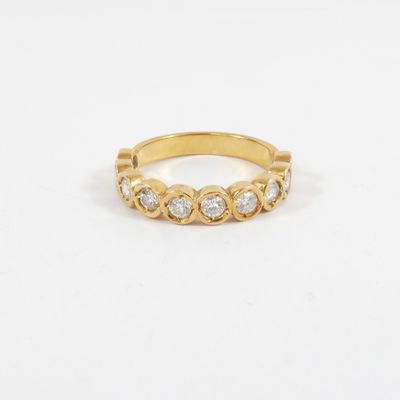 a gold ring with three diamonds on the side