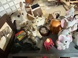 many stuffed animals sitting on a table in a room