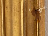 a close up of a gold frame with a clock on it