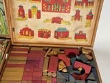 a wooden box filled with wooden blocks in it