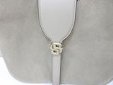 the back of a white purse with a gold buckle on it
