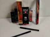 the contents of a makeup set including mascara, eyeliners, and mascara brush