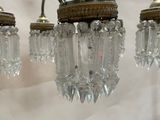 three glass chandeliers hanging from the ceiling