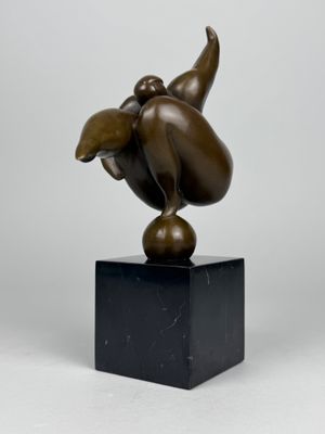 bronze sculpture of a bird on a black marble base